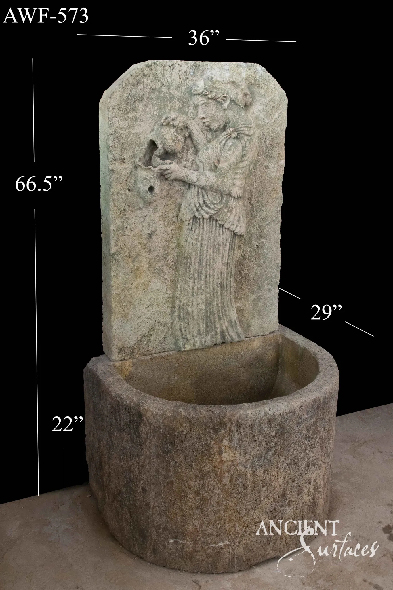 Limestone wall fountain carved with a classical maiden relief above a round stone basin